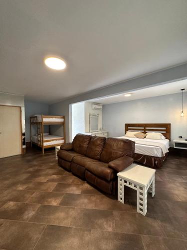 a living room with a couch and a bed at VPX Hoteles Cieneguilla in Cieneguilla