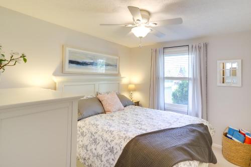 a bedroom with a bed with a ceiling fan and a window at Three Oaks Home with Guest House - 8 Mi to Beach! in Three Oaks