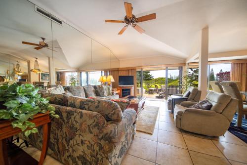 a living room with couches and a ceiling fan at Kapalua Villas Maui in Lahaina