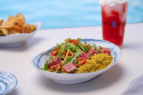 a bowl of food on a table with a salad at The STRAT Hotel, Casino & Tower in Las Vegas