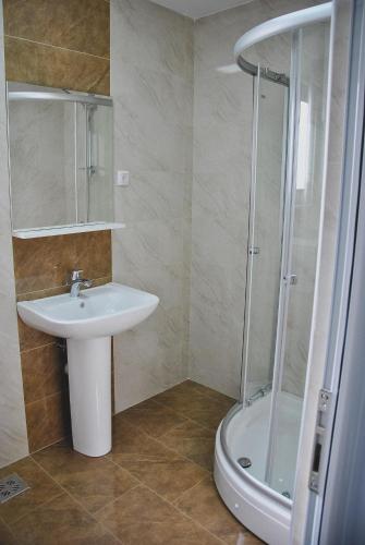 a bathroom with a sink and a shower at Lantana in Ulcinj