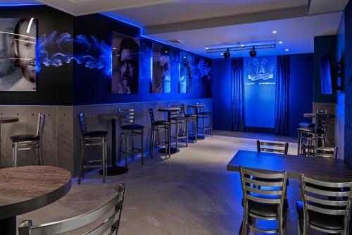 a row of tables and chairs in a restaurant with blue lighting at The STRAT Hotel, Casino & Tower in Las Vegas