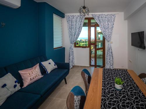 a blue living room with a couch and a table at Buongiorno! Premium in Sveti Vlas