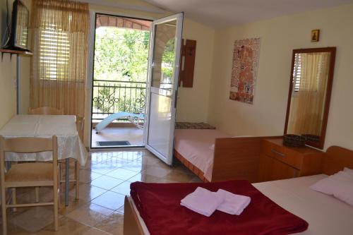 a room with a bedroom with a bed and a table at Apartments Milosevic in Bar