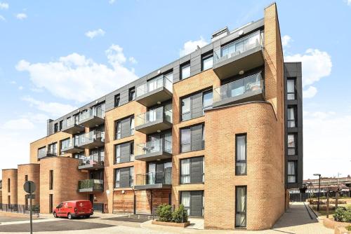 a red van parked in front of a brick building at Kew Bridge Penthouse in London