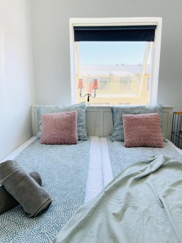 a bedroom with two beds and a window with a view at Randers residence Sankt Andreas - 2 room apartment in Randers