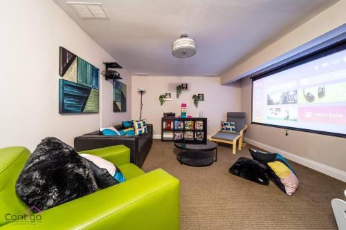 a living room with a large screen in a room at Cozy 3BD w/AC, Patio, Theatre Room, 15 min to DT in Edmonton