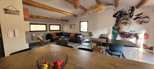 - un salon avec une grande table et des chaises en bois dans l'établissement L'ENTRE POTES - Maison de caractère climatisée avec garage, à Villedieu
