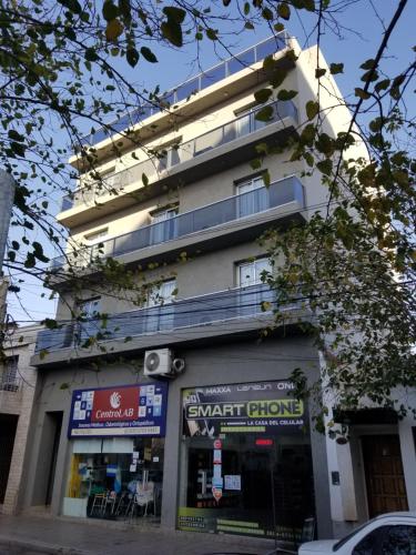 a building with a smart store in front of it at DELFINA suites 3A in La Rioja