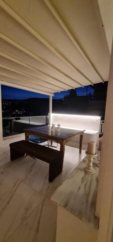 a room with a table and a view of the city at Euphoria luxury penthouse in Kavala