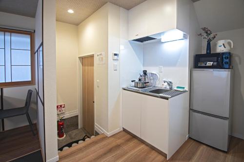 a small kitchen with a sink and a refrigerator at -時の宿 二条- 二条城前駅 Toki Nijo RoomA in Kyoto
