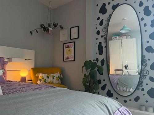 a bedroom with a bed and a large mirror at Stunning Bright Two Bedroom Apartment In Southbourne in Southbourne