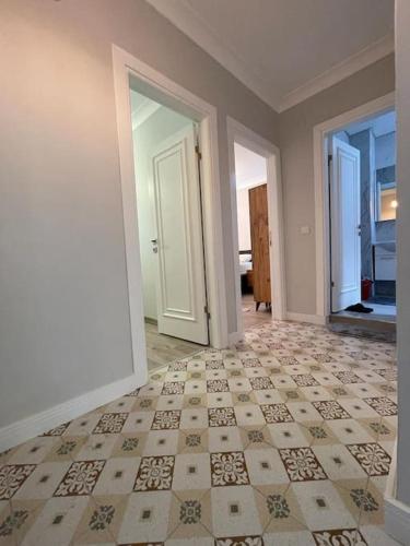 an empty room with a tile floor and two doors at The VIP Guest - Luxury Home in Nisantasi in Istanbul