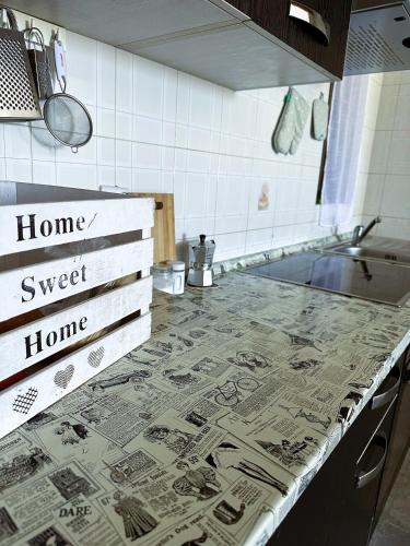 a kitchen with a counter top with signs on it at St Julian Rainbow in St Julian's
