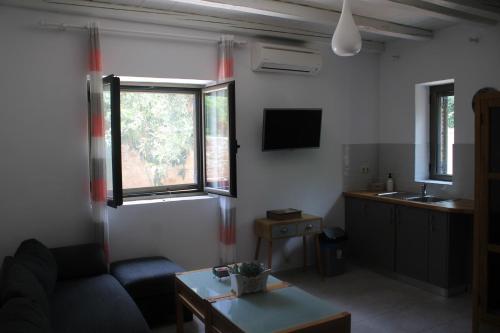 a living room with a couch and a window at Magnificent, Authentic Private Villa and the Guest house in Kardamili