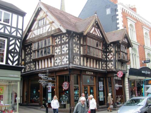 un edificio en una calle con gente caminando delante de él en Ludwick Apartment en Shrewsbury