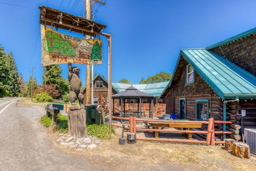 a log cabin with a large sign in front of it at The Logs in Snowden