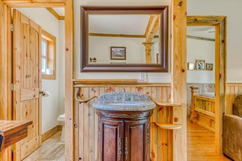 a bathroom with a sink and a mirror at The Logs in Snowden