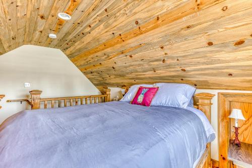 a bedroom with a wooden ceiling with a bed at The Logs in Snowden