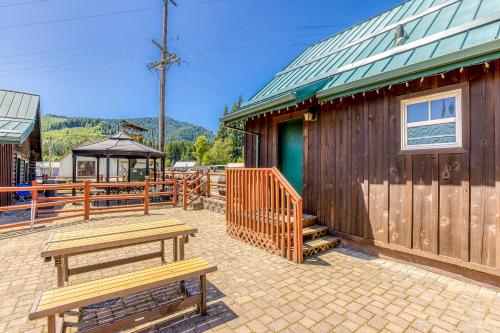 a patio with benches next to a wooden building at The Logs in Snowden
