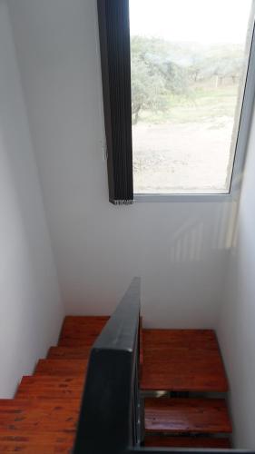Zimmer mit einem Fenster und einer Treppe in der Unterkunft MONTEARENA POTRERO DE LOS FUNES in Potrero de los Funes