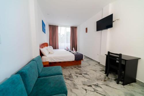 a hotel room with a couch and a bed at Patty House Galapagos in Puerto Ayora