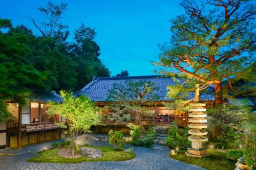 a garden with a tree and a building at Suiran, a Luxury Collection Hotel, Kyoto in Kyoto