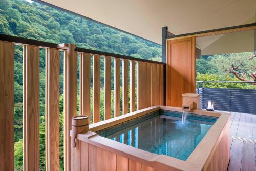 a swimming pool in a house with a mountain view at Suiran, a Luxury Collection Hotel, Kyoto in Kyoto