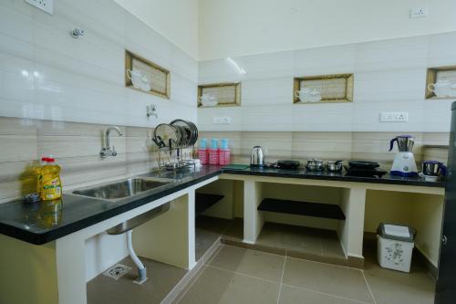 a kitchen with a sink and a counter at Live Inn JP Nagar in Tiruchchirāppalli