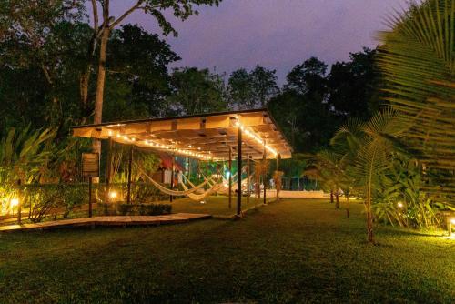 a pavilion with lights in a park at night at Cabañas Kin Balam Palenque in Palenque
