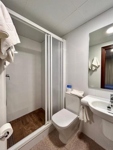 a bathroom with a shower and a toilet and a sink at Pensión La Orozca Benidorm in Benidorm