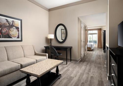 a living room with a couch and a table at West Inn & Suites in Carlsbad