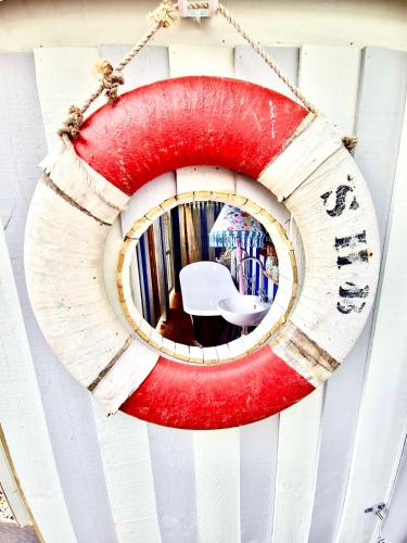 a circular mirror hanging on a wall at Glamping in Luxury at Little Lytelton Boatique House in  Lyttelton