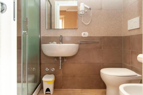 La salle de bains est pourvue d'un lavabo, de toilettes et d'un miroir. dans l'établissement Domus Porta Angelica, à Rome