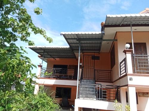 a house with a porch and a balcony at Hidden Gem in Ban Na No