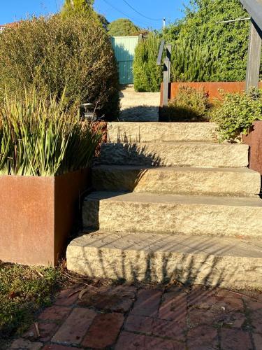 a set of stone steps leading to a house at Beach House, Stunning Views of Kingston Beach in Kingston Beach