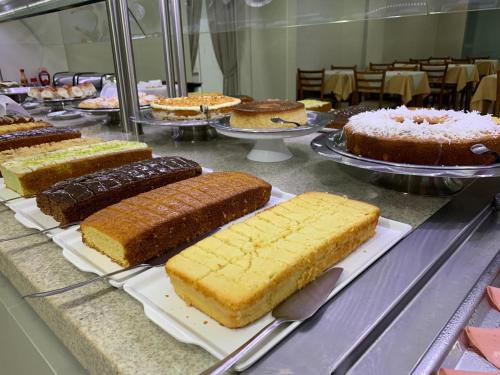 a bunch of cakes on display in a buffet at Varadero Palace Hotel in Florianópolis