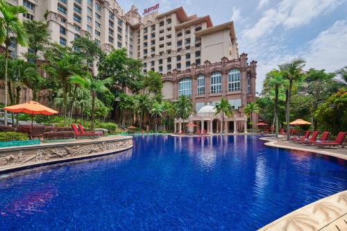 a large swimming pool in front of a hotel at Putrajaya Marriott Hotel in Putrajaya