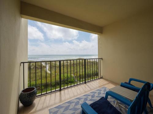 a balcony with two chairs and a view of the ocean at Jacksonville Sea Spray 2B, 1 Bedroom, Beachfront, Sleeps 2 in Jacksonville Beach