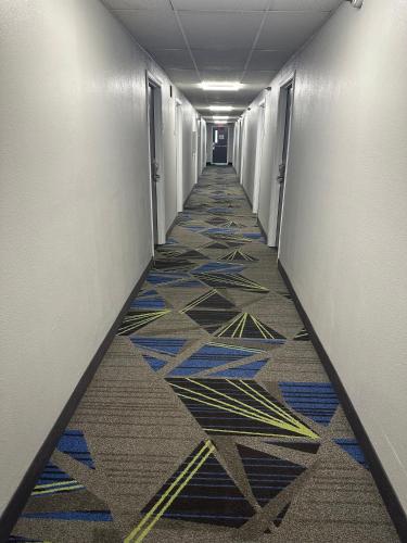 a hallway with a colorful tile floor in an office building at La Quinta Inn by Wyndham Omaha Southwest in Omaha