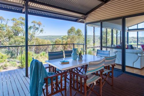 a patio with a table and chairs on a deck at Matilda I Private Properties in Dunsborough