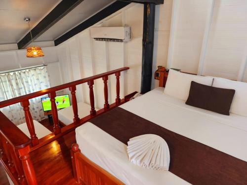 a bedroom with two beds and a television in it at The Crow's Nest Resort Fiji in Korotogo