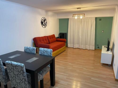 a living room with a couch and a table and chairs at Departamento Irigoyen in Trelew
