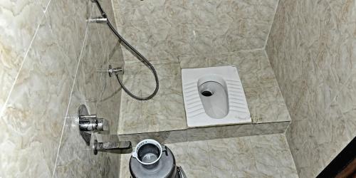 a bathroom with a shower with a toilet in it at ASRA DORMITORY For Male And Female in Mumbai