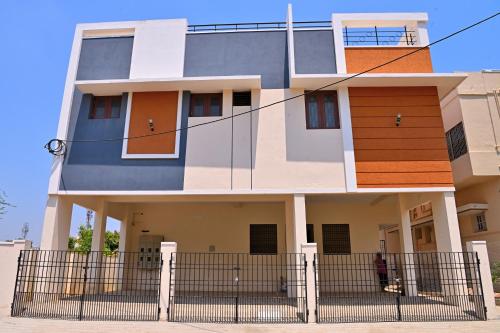 a building with a fence in front of it at Live Inn JP Nagar in Tiruchchirāppalli