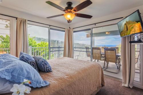 a bedroom with a bed and a large window at Lillikoi in Honolulu