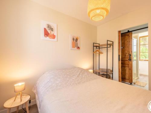 1 dormitorio con 1 cama blanca y 1 lámpara en Appartement Bonnières, 2 pièces, 2 personnes - FR-1-526-37 