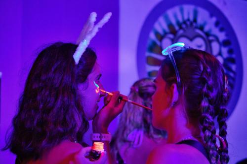 two women in a purple room brushing their teeth at The Funky Monkey Hostel - 18 to 40 years old only in Haad Rin