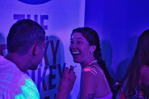 a woman is laughing in a room with a man at The Funky Monkey Hostel - 18 to 40 years old only in Haad Rin