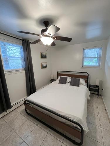 a bedroom with a bed and a ceiling fan at Two Bedroom Private Apt near NYC in West New York